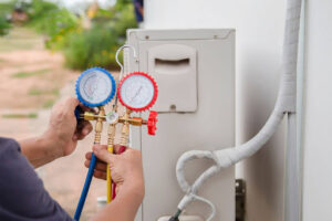 GEN3 HVAC technician using manifold gauge to measure AC performance