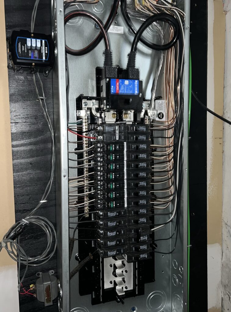 Upgraded electrical panel with clean wiring and new breakers, showing a safer setup that helps prevent issues when breakers trip in winter.