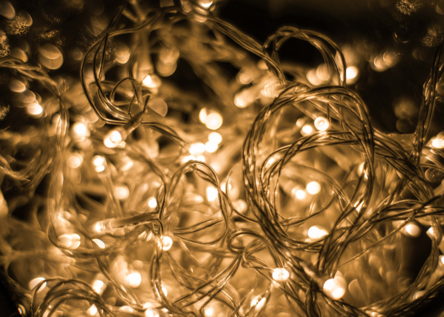Tangled warm white LED Christmas lights illustrating potential electrical overload risks.