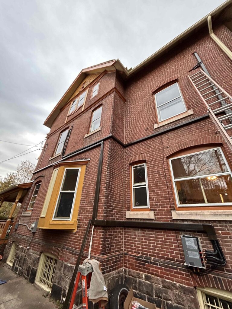 “Exterior of a historic Philadelphia home with newly installed mini split line-hide and branch box routing, completed as part of a Philadelphia mini split installation.